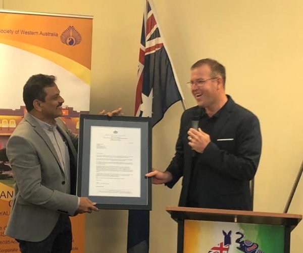 Surya Ambati receiving recognition for outstanding contributions to the community.